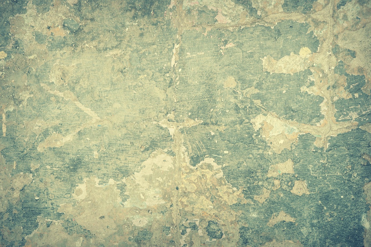Epoxy crack injection ports anchored into a vertical poured concrete foundation crack.