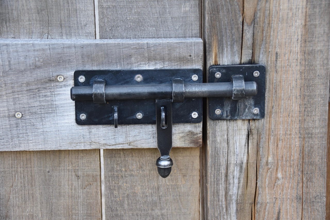 Disassembled center gearbox mechanism for a residential multi-point door lock lying on a workbench.