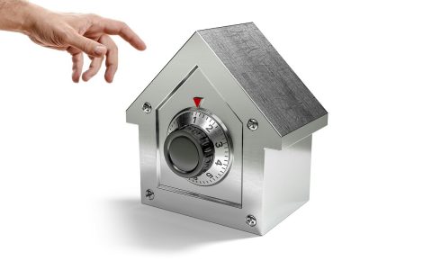 Close-up view of a stainless steel multi-point locking system installed on the edge of an open exterior French patio door.