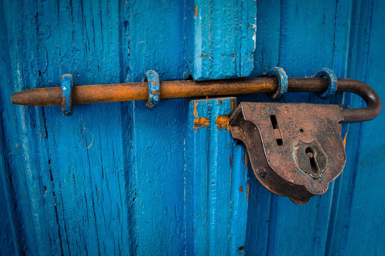 Comparing an electronic solenoid door lock switch to a thermal wax motor interlock component.