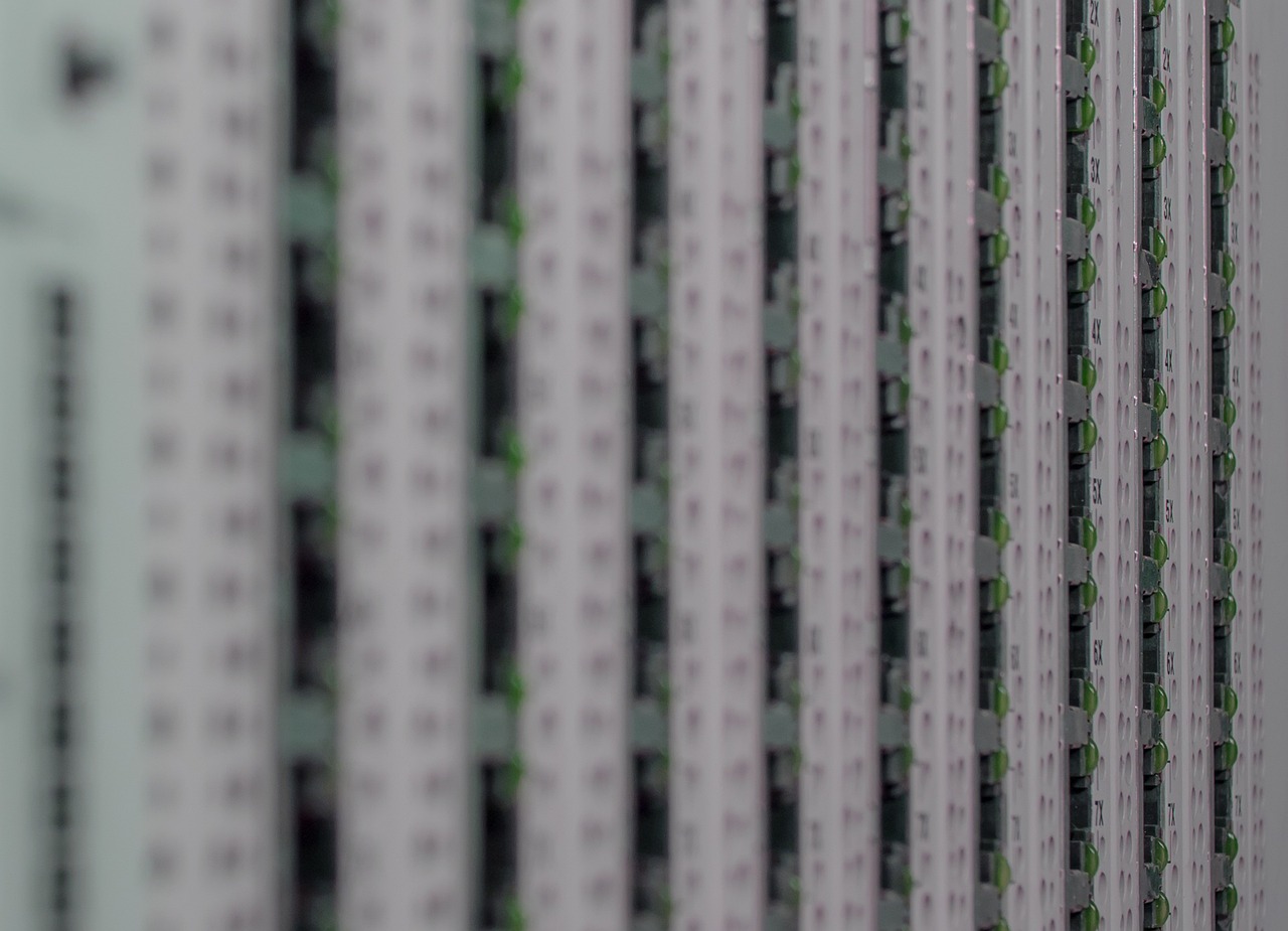 A managed Gigabit network switch with color-coded Ethernet cables establishing isolated network segments.
