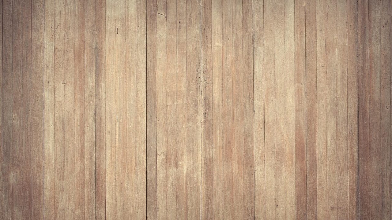 Contractor using a heavy drum sander on residential hardwood floors.