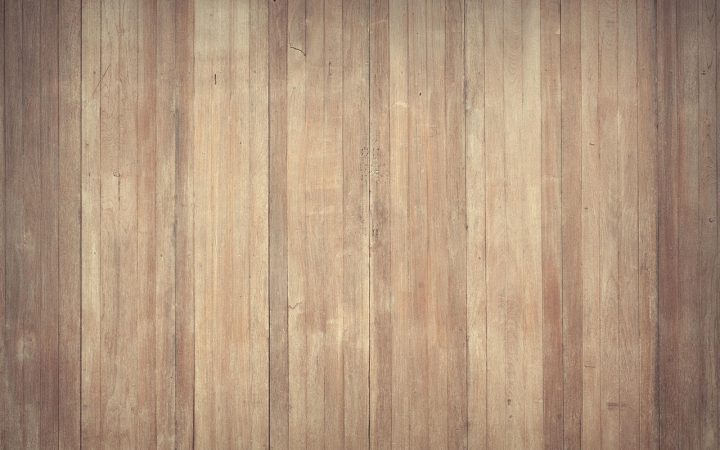 Contractor using a heavy drum sander on residential hardwood floors.