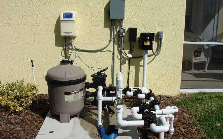 A modern hybrid heat pump water heater installed in a clean basement utility space.