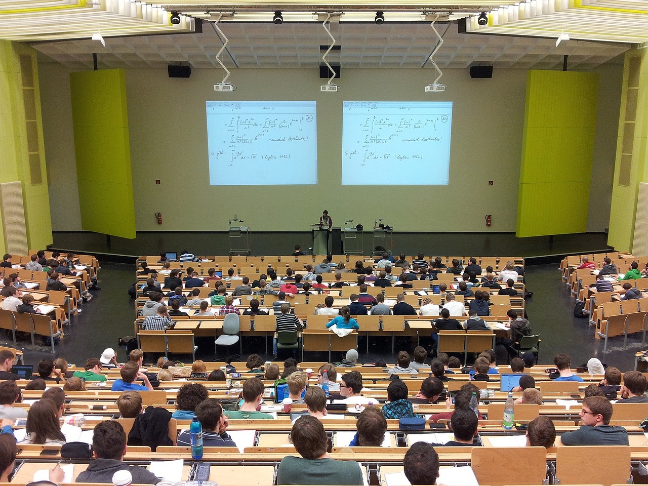 College students seated in a lecture hall attending an introductory university course.