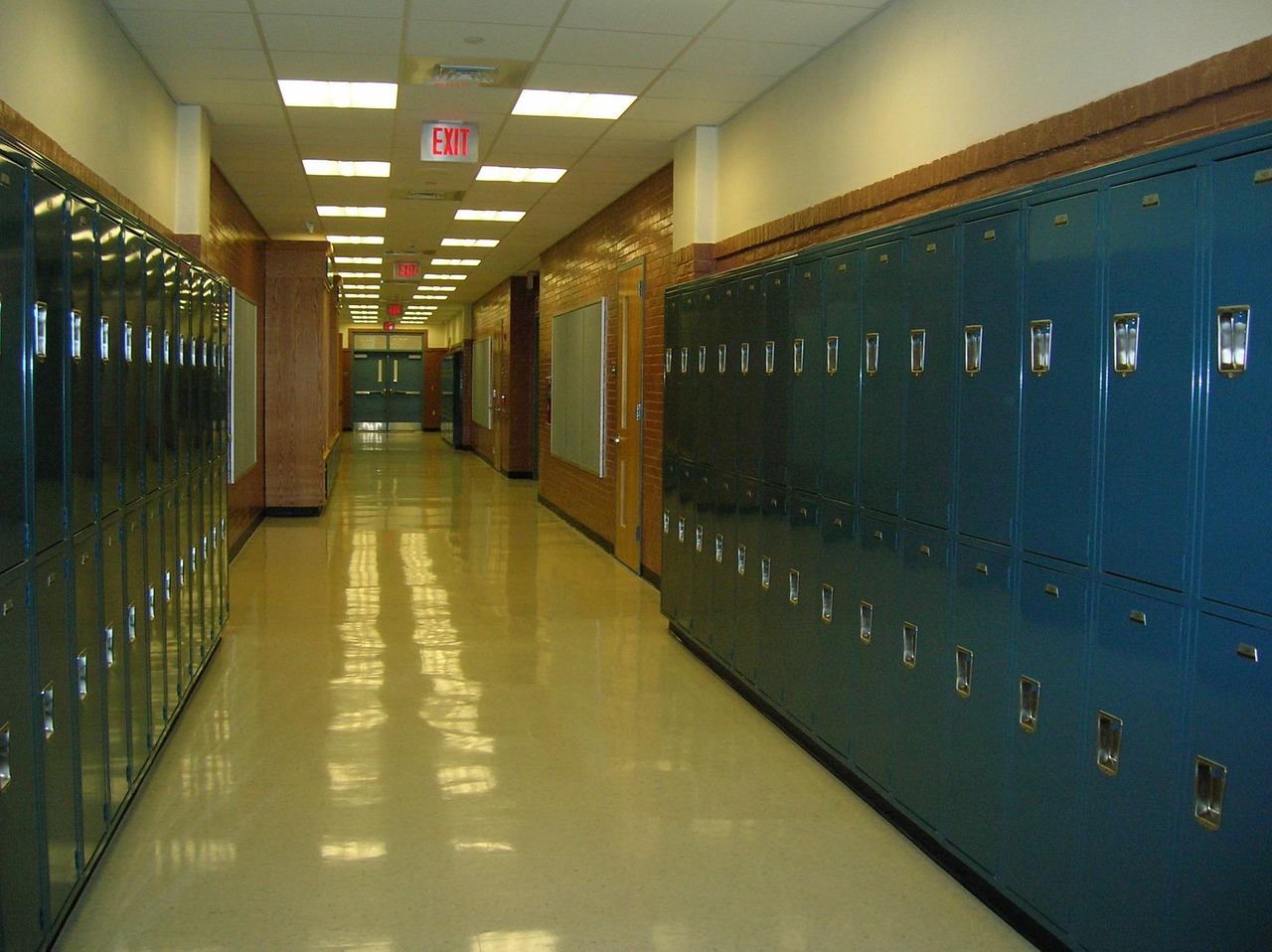 Empty high school hallway with lockers and classroom doors