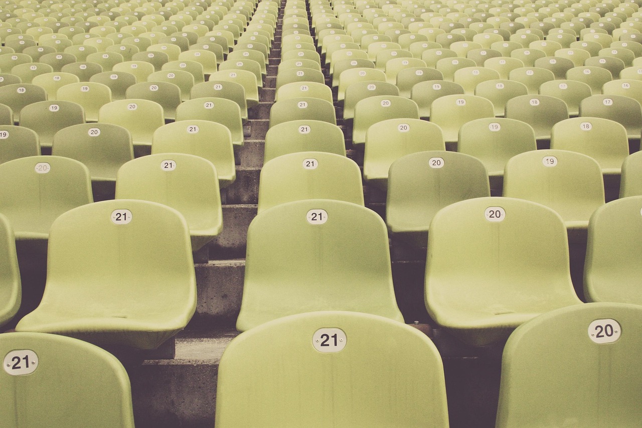 Empty high school football stadium bleachers and field