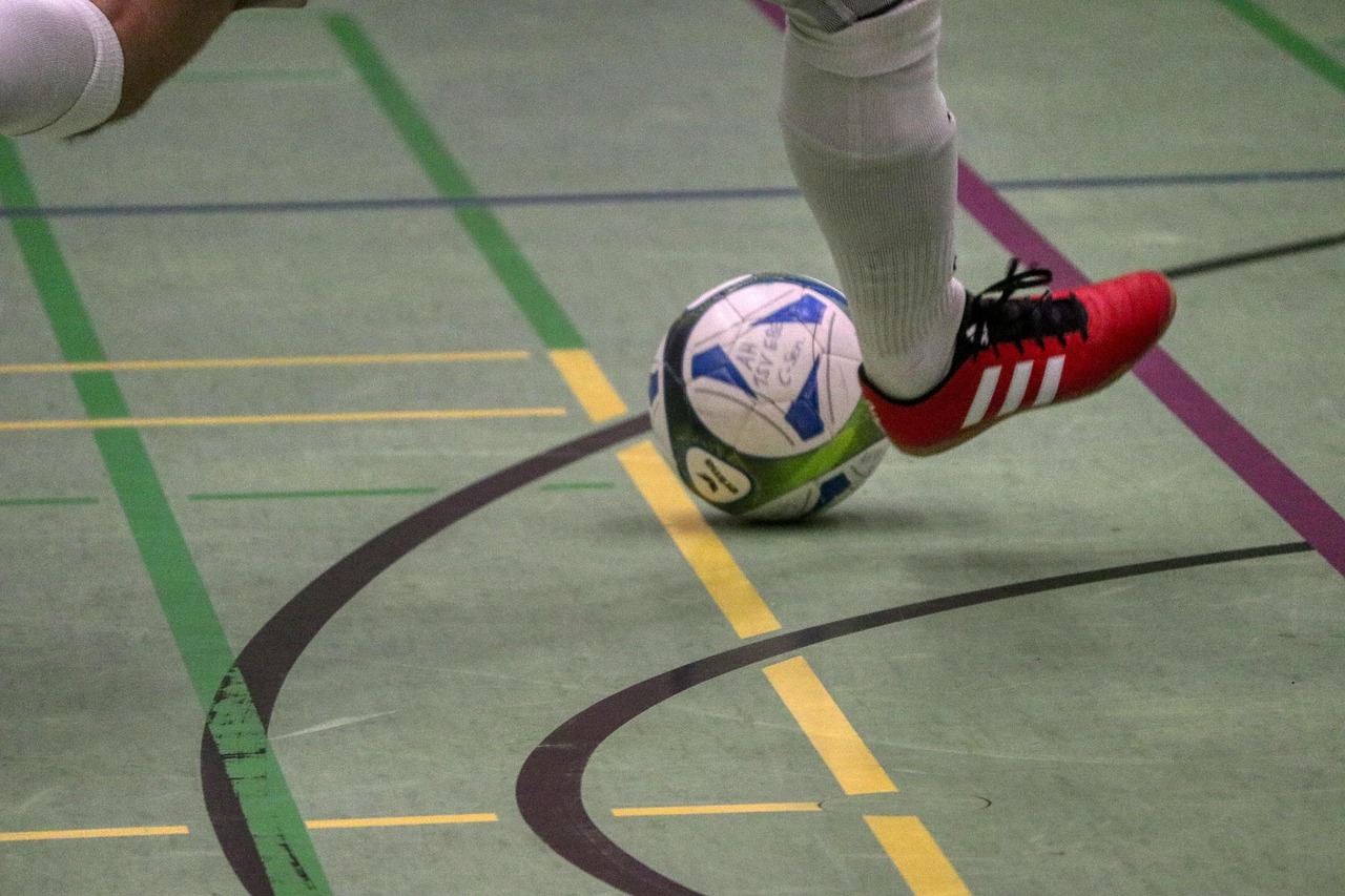 Athletic gear and equipment laid out on a wooden floor