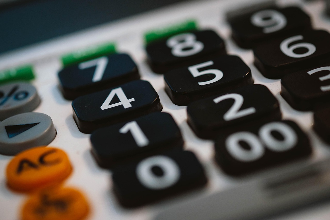 A student organizing campaign expense receipts alongside a calculator and campaign planning notes.