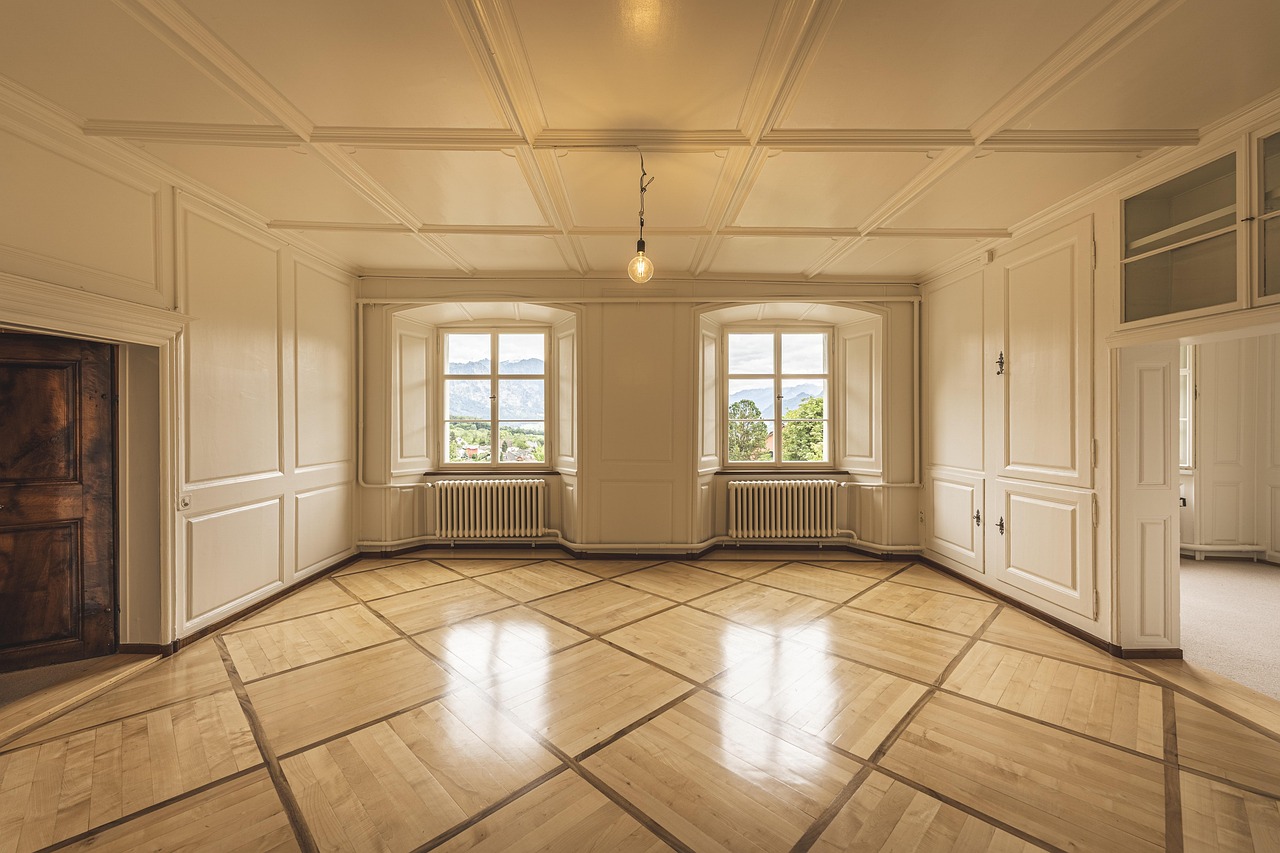 A magnifying glass positioned over itemized real estate closing costs on paper.