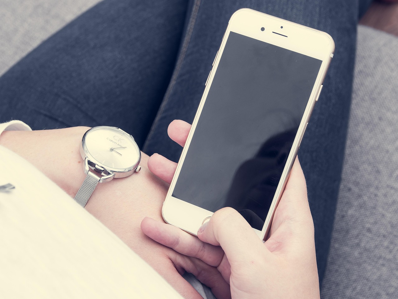 Homeowner checking a smart home security application on a mobile phone.