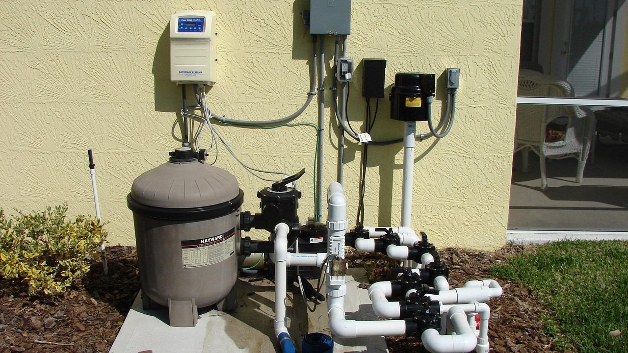 A clean residential utility room featuring a modern HVAC system and hot water heater.