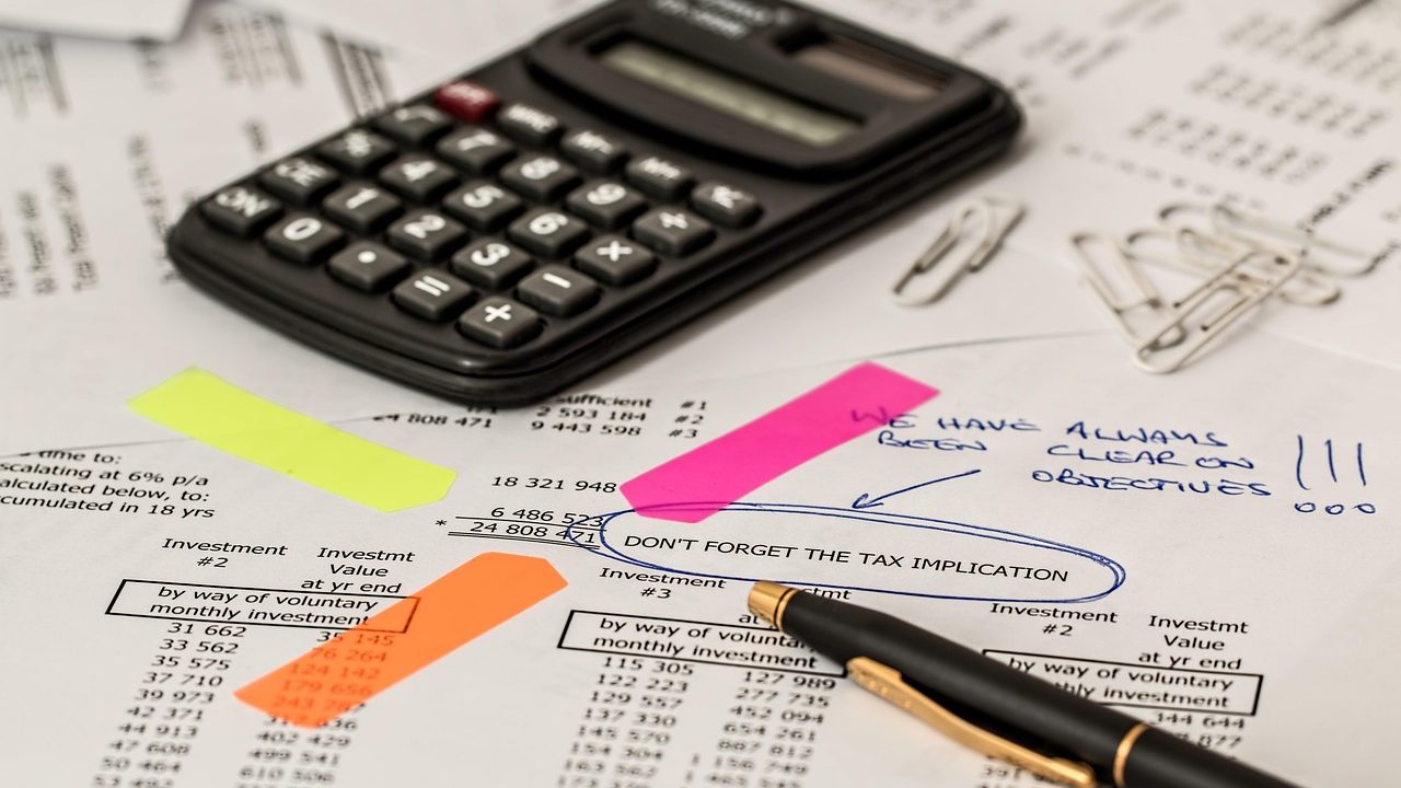 A homeowner reviewing insurance policy documents at a wooden table