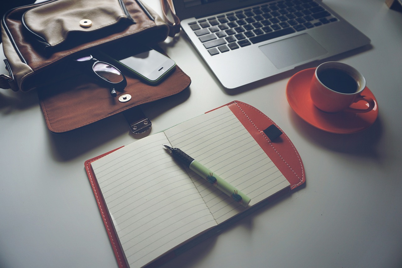 A neatly organized office desk showing financial calculations and professional training proposal plans.