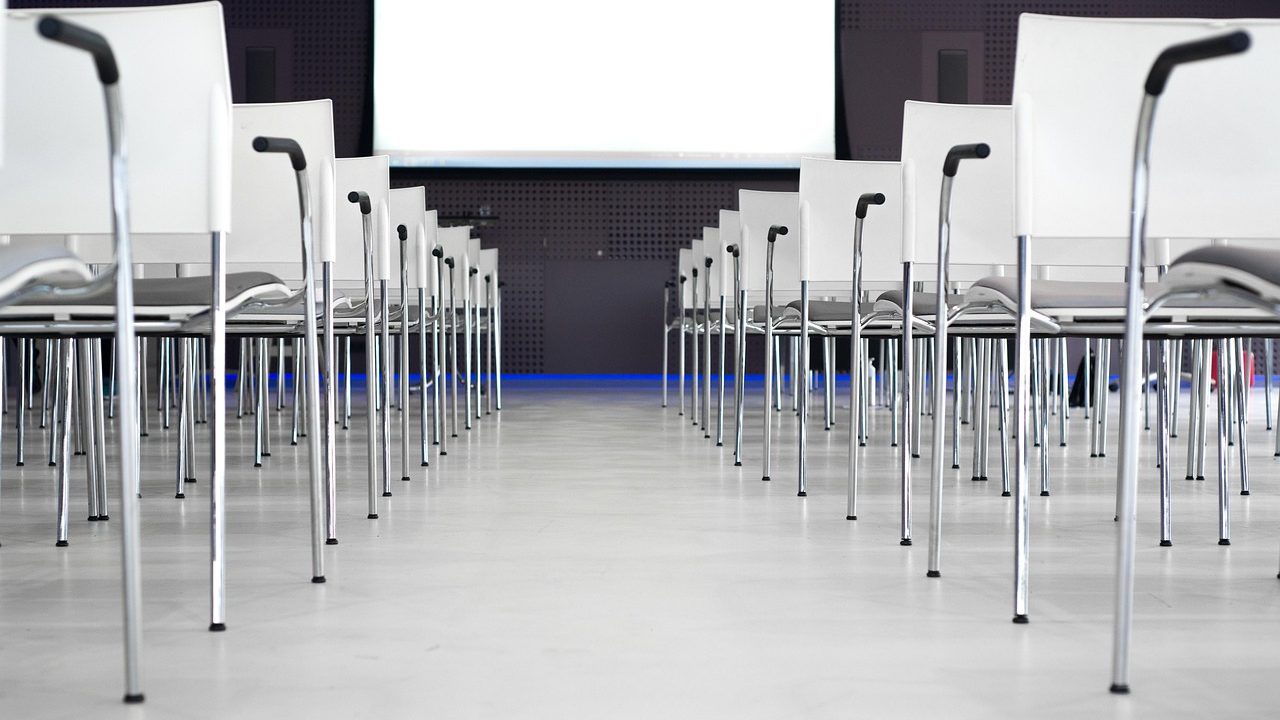 A professional presenting a business pitch in a modern corporate conference room.