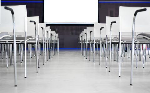 A professional presenting a business pitch in a modern corporate conference room.
