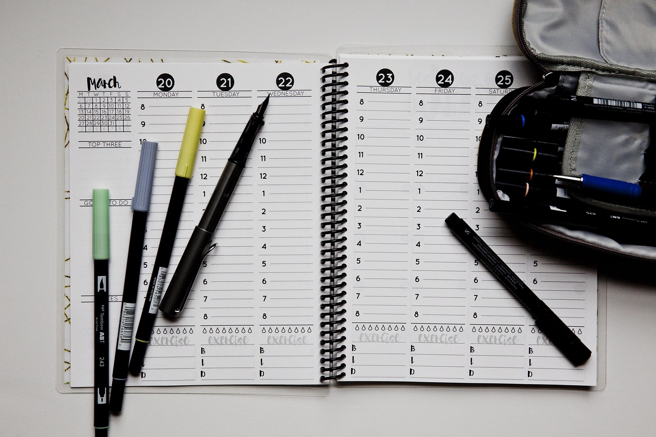 Organized workspace with a planner detailing sabbatical timeline planning