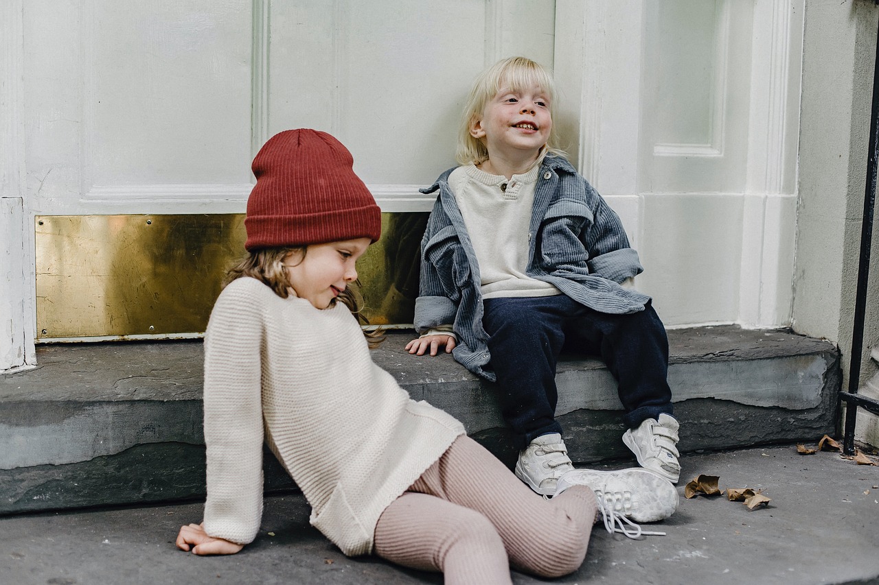 Family members playing with young children in a backyard setting.