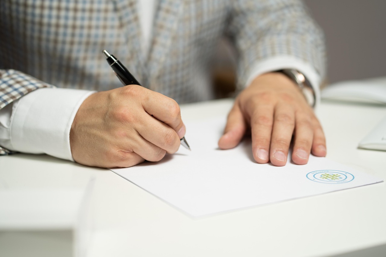 A parent signing official guardianship nomination forms.