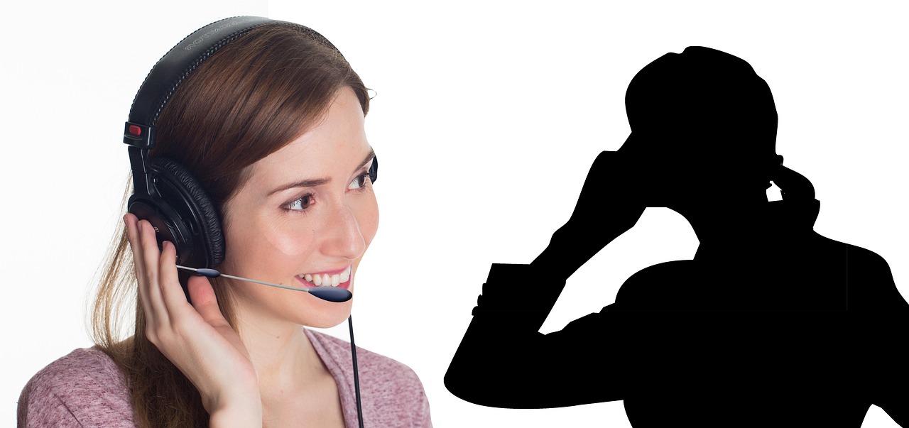 A person on a phone call while consulting organized medical billing folders and written notes.