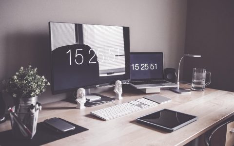 A modern professional office desk setup with a financial document and laptop displaying equity compensation models.