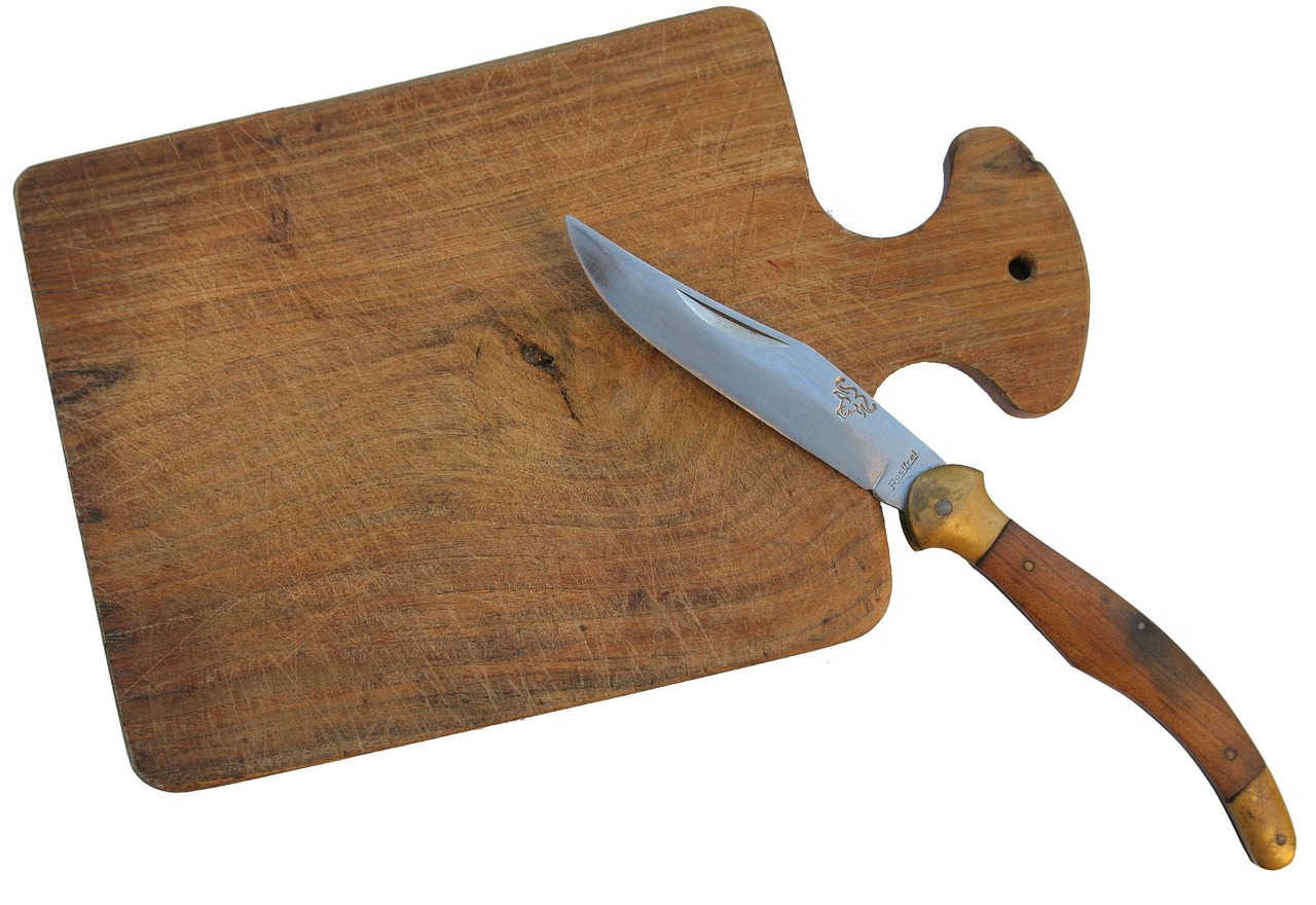 Using a utility knife to carefully score a painted window joint.