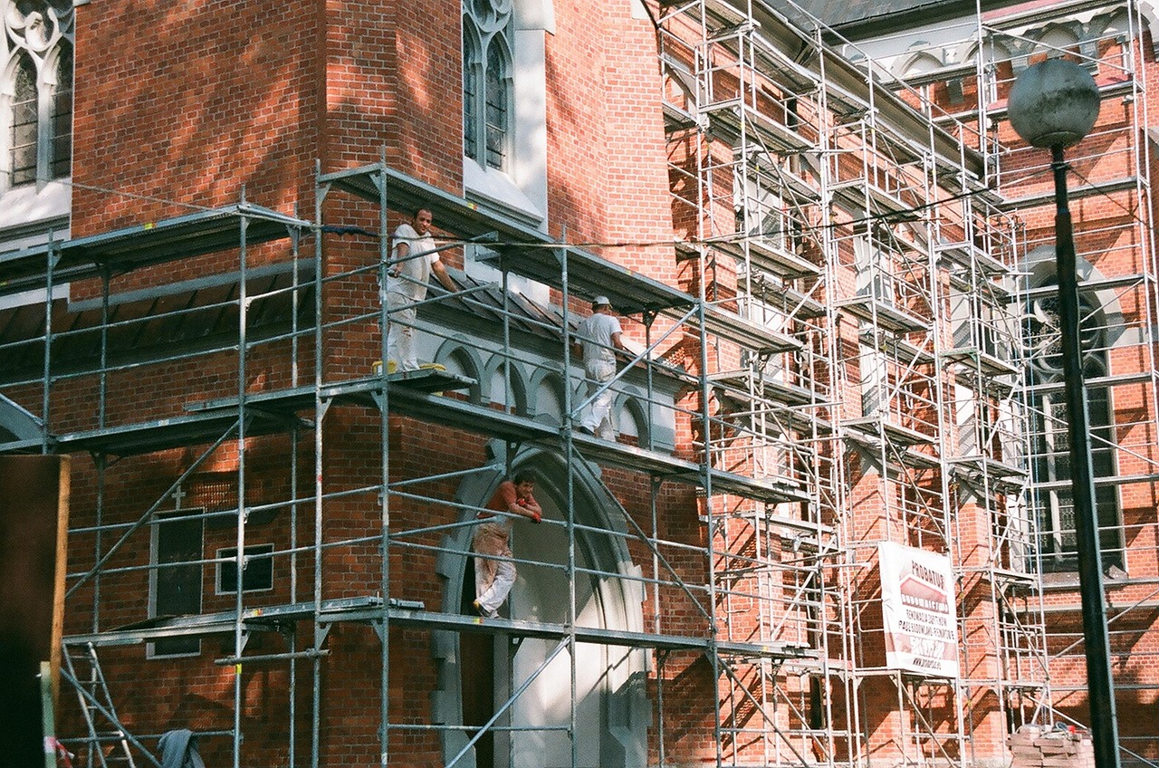 A homeowner and a general contractor reviewing renovation specifications together inside a residential home.
