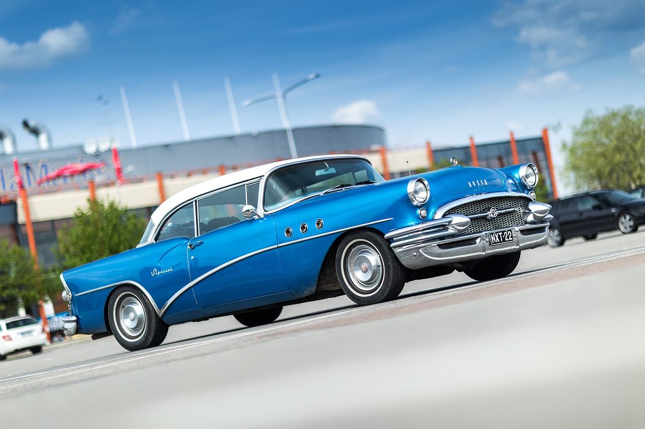 A classic car safely strapped inside a clean enclosed vehicle transport trailer