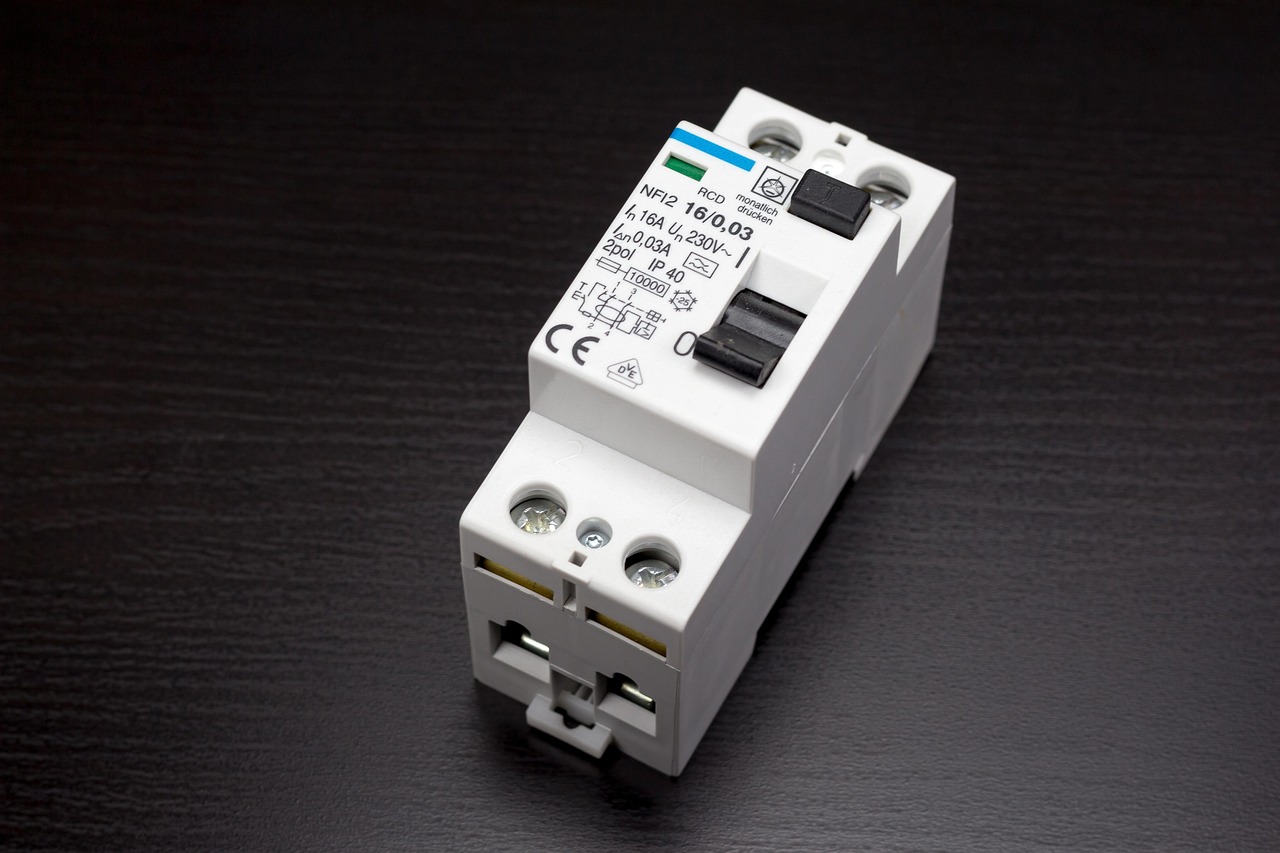 A modern main breaker panel with neat copper wiring and grounded circuit breakers.
