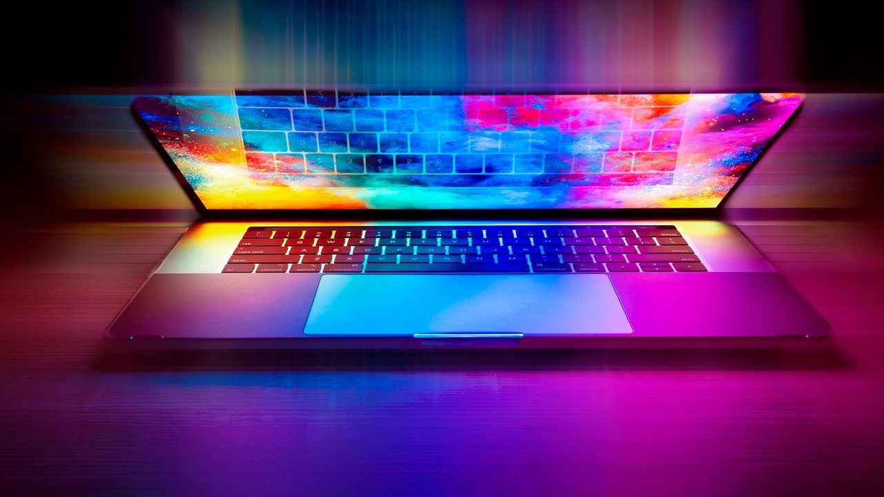 A modern laptop on an executive desk running a local offline transcription program showing audio waveforms.