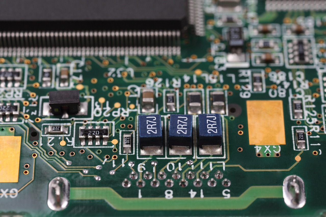 A technician carefully installing a component into a circuit board during an electronic repair.