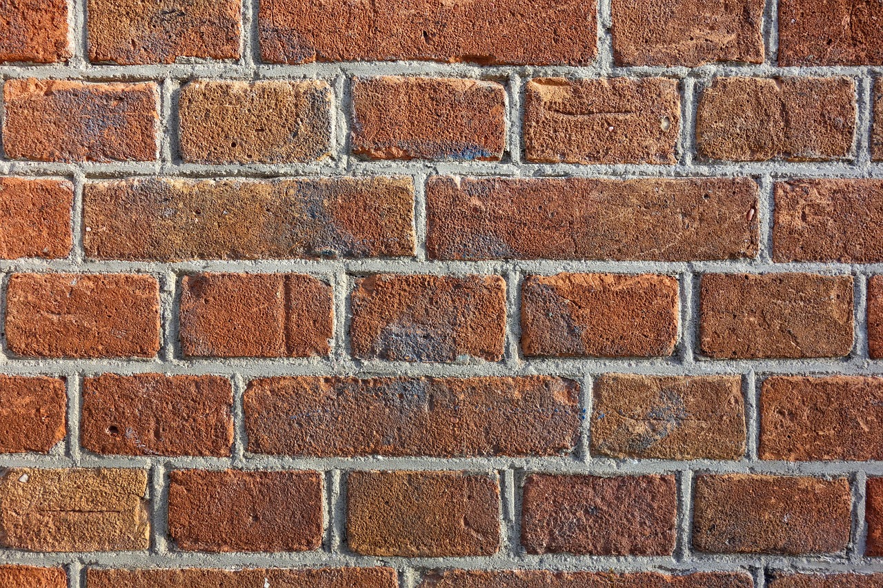 Metal scaffolding erected against a brick residential building