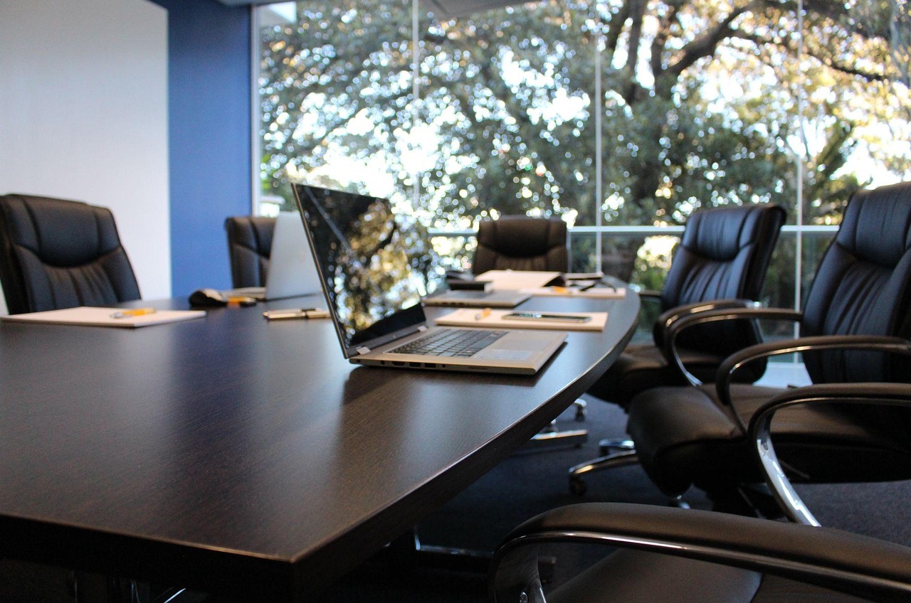 Two professionals discussing strategy during a corporate interview meeting.