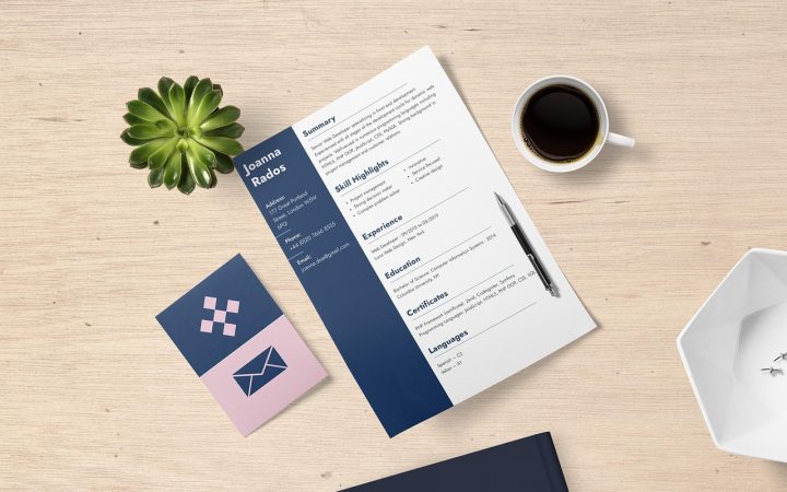 Professional reviewing a resume and career portfolio at a modern office desk.
