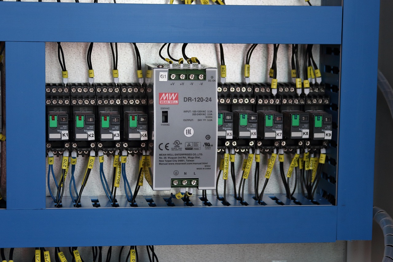 Open industrial electrical control cabinet with wiring