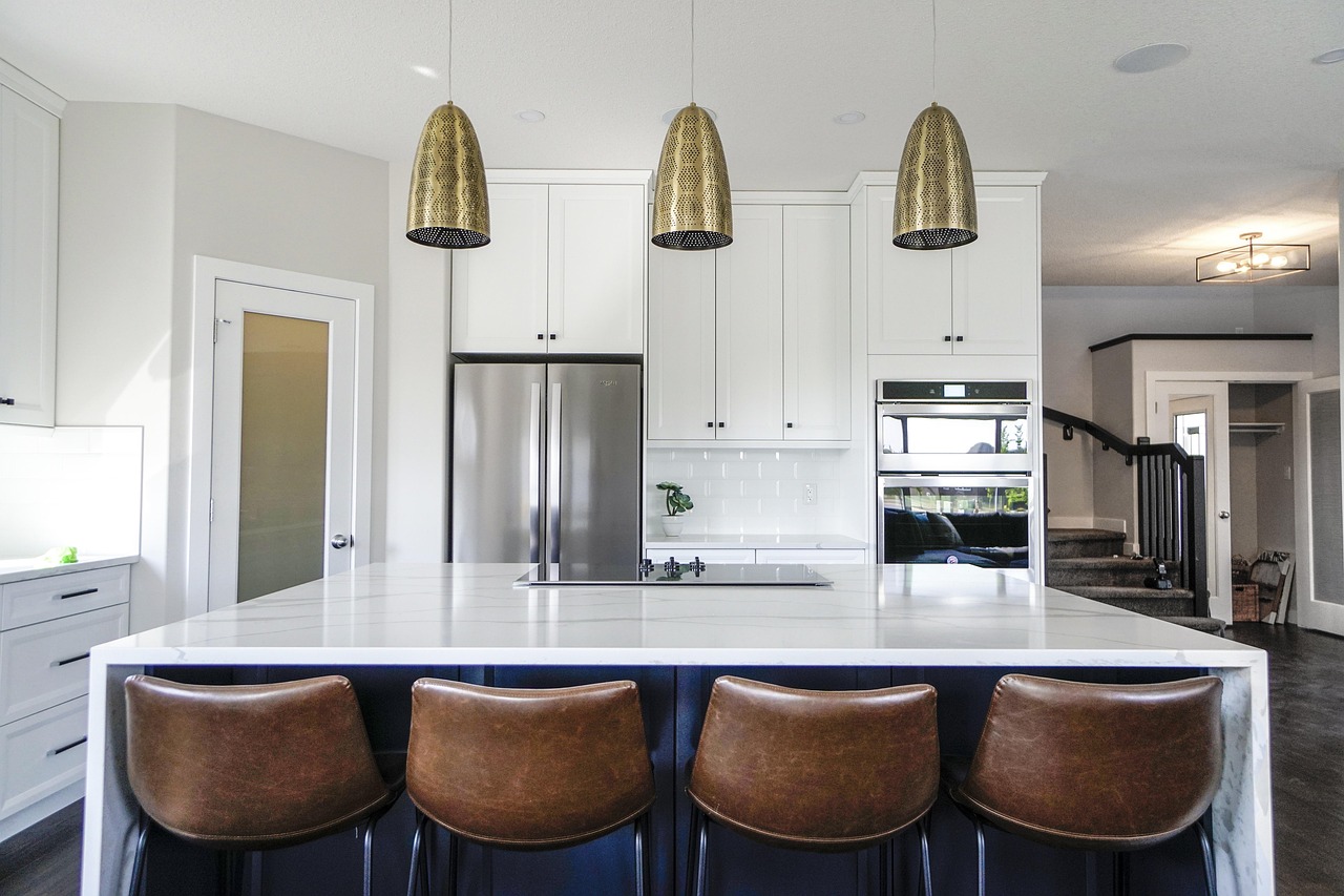 A brand new stainless steel refrigerator installed in a clean, modern American kitchen.