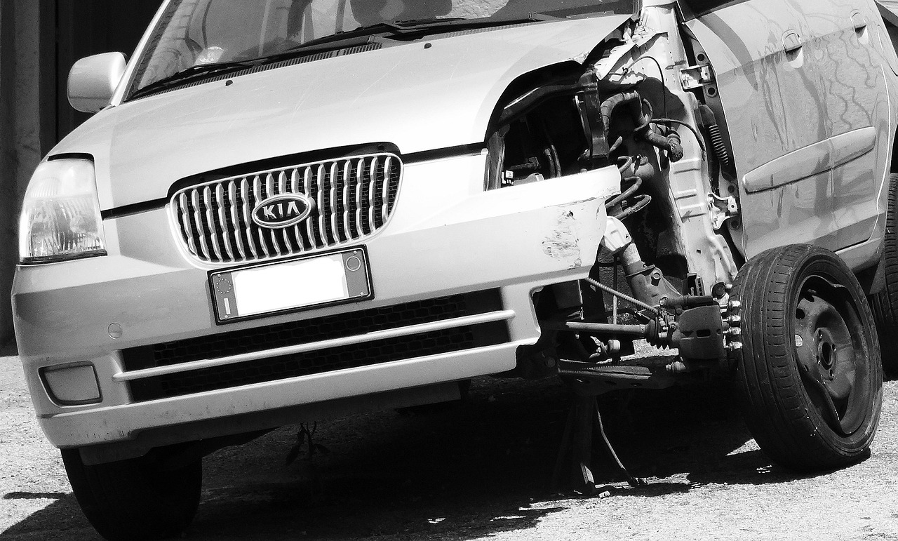 Collision estimator reviewing repair options and estimate line items with a car owner.