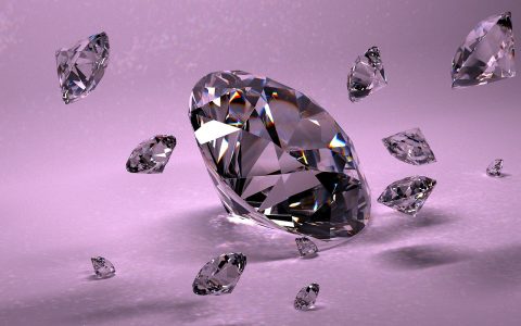 A brilliant-cut diamond sitting next to a gemological lab report and jeweler loupe.
