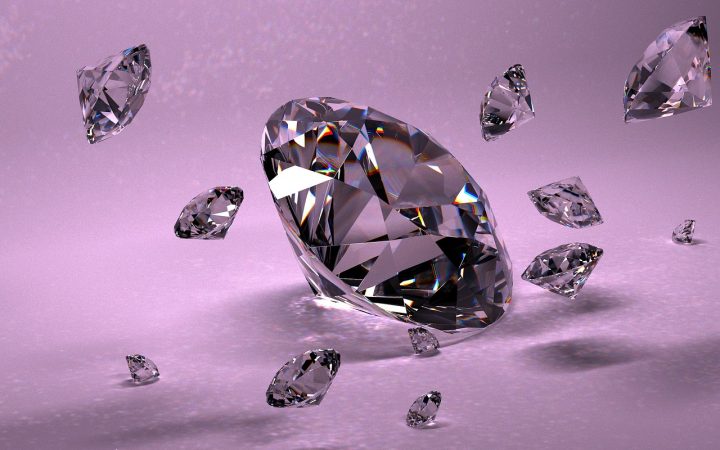 A brilliant-cut diamond sitting next to a gemological lab report and jeweler loupe.