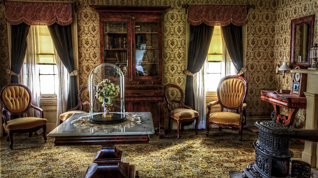Vintage mid-century furniture and packed boxes inside a residential room during an estate sale pickup