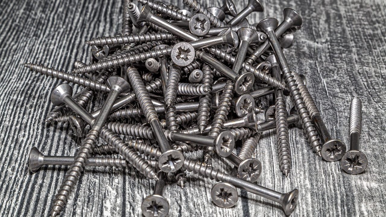 Commercial cast iron skillets and stainless steel prep gear arranged on a commercial worktable.