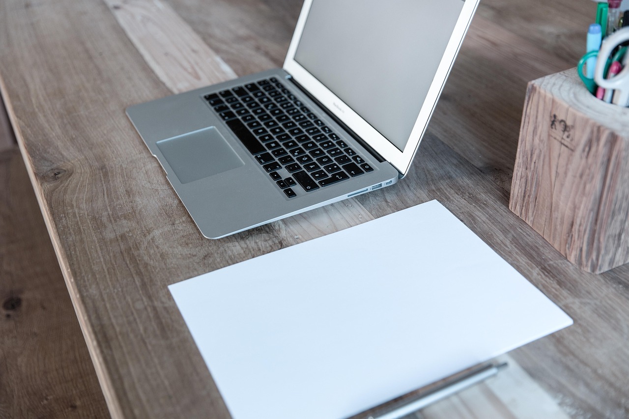 External solid-state drive connected to a laptop on a wooden desk setup