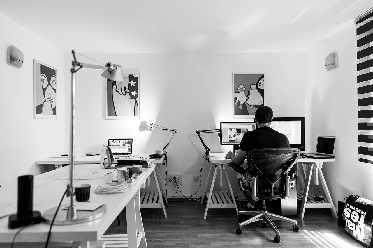 Developer working focused at a minimalist computer workstation
