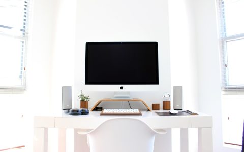 Modern workstation desk with dual monitors running local developer applications in a brightly lit room