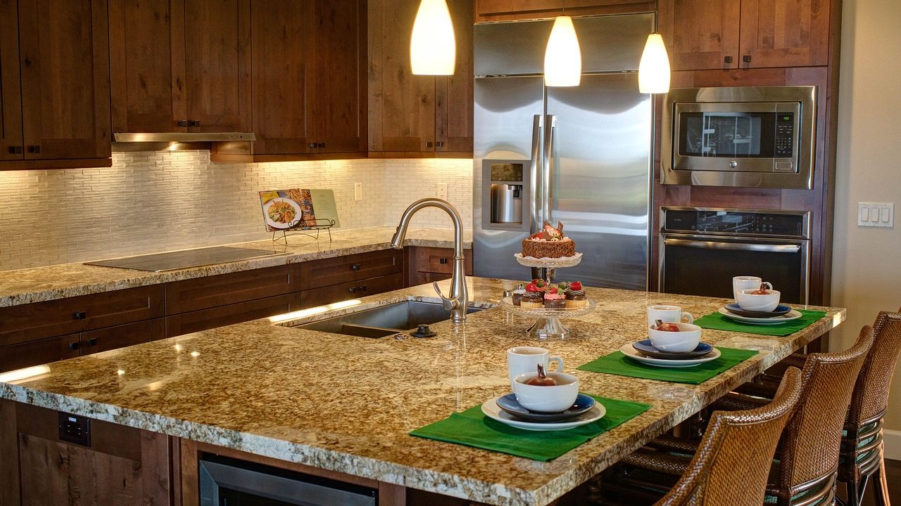 Stainless steel over-the-range microwave installed above a gas range.