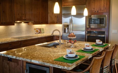 Stainless steel over-the-range microwave installed above a gas range.