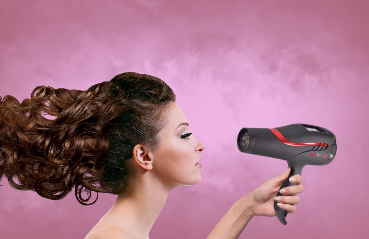 Renter loading clothes into a compact portable dryer