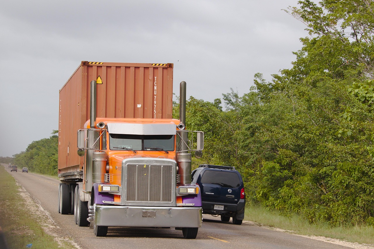 Freight truck delivering boxed commercial equipment to a residential driveway