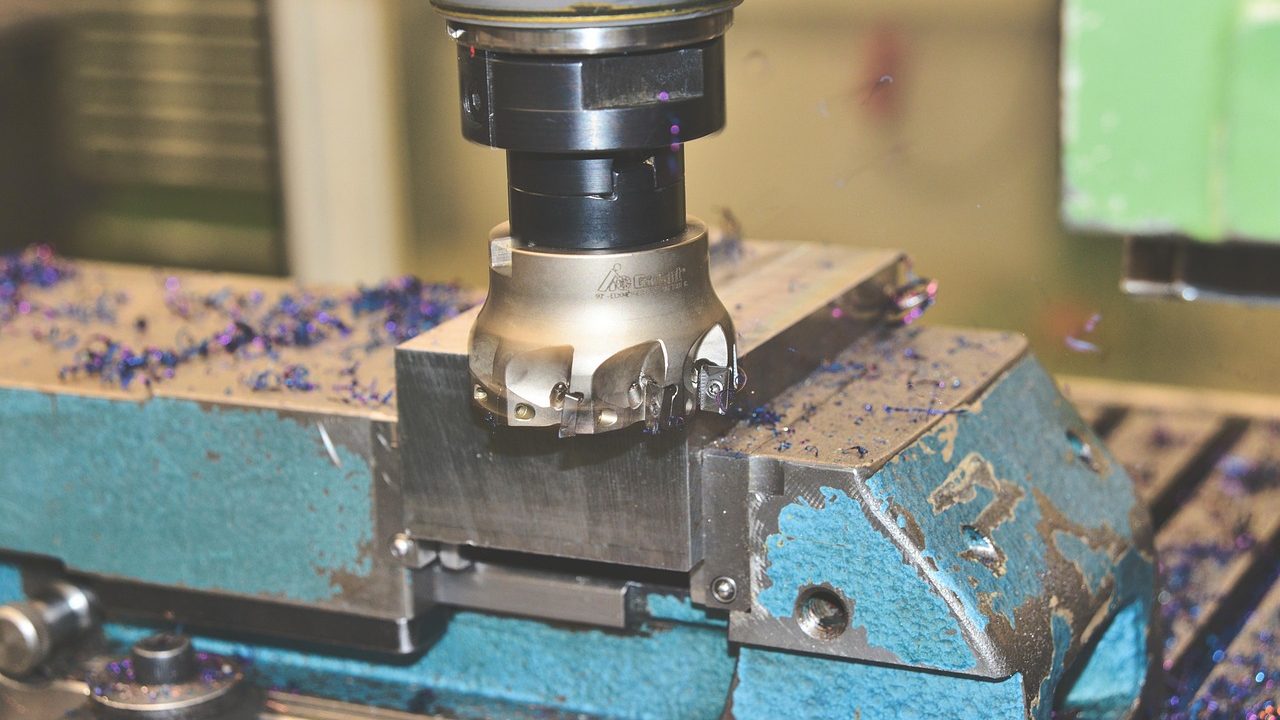 Commercial multi-needle embroidery machine on a workbench in a bright home workshop