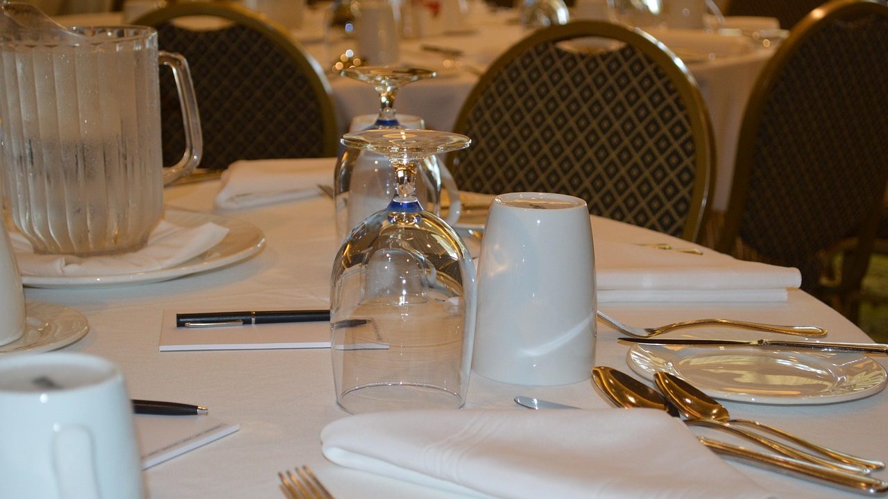 A modern conference room table with a professional speakerphone setup ready for a hybrid meeting.